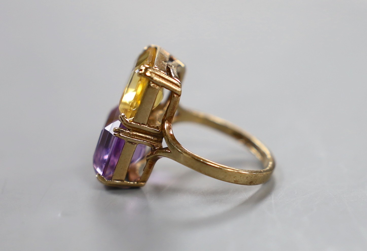 A mid 20th century 9ct gold, amethyst and citrine set two stone dress ring, size N, gross weight 5.2 grams.